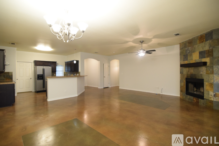 A spacious living room with a fireplace and a television.