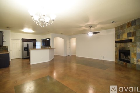 A spacious living room with a fireplace and a television.