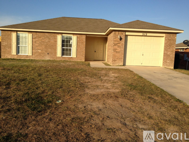 A house with a garage and a driveway in front.