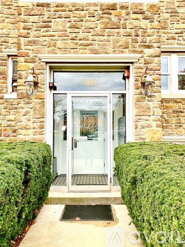 The front door of a house with a glass window and a glass door.