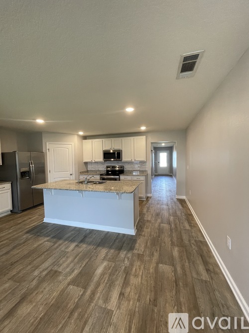 A kitchen with a white island in the middle of the room.