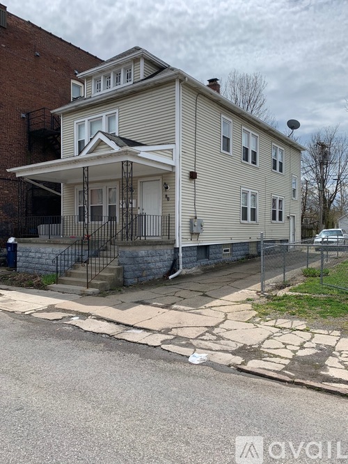 A two-story house with a garage on the side.