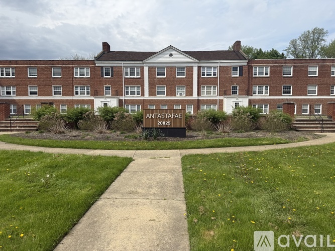 A brick building with a sign that says "ANTASTAFAE 20825" in front of it.