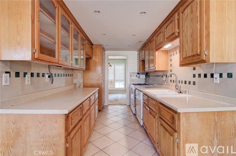 A kitchen with wooden cabinets and a white countertop.