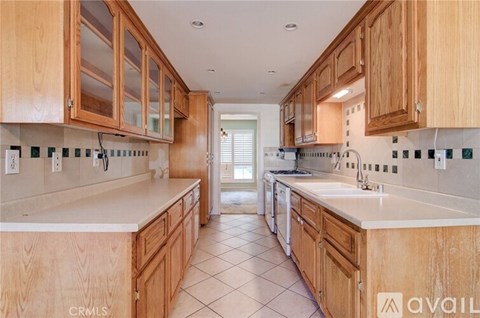 A kitchen with wooden cabinets and a white countertop.