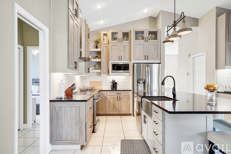 A modern kitchen with wooden cabinets and a black countertop.
