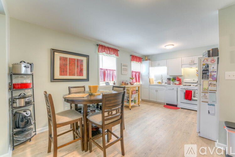 A kitchen with a table and chairs in the middle of the room.