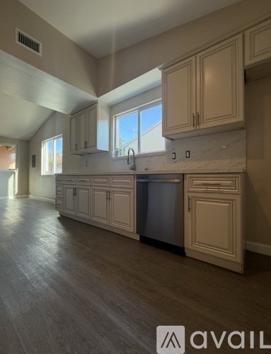 A kitchen with wooden cabinets and a dishwasher.