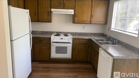 A kitchen with wooden cabinets and a white refrigerator.