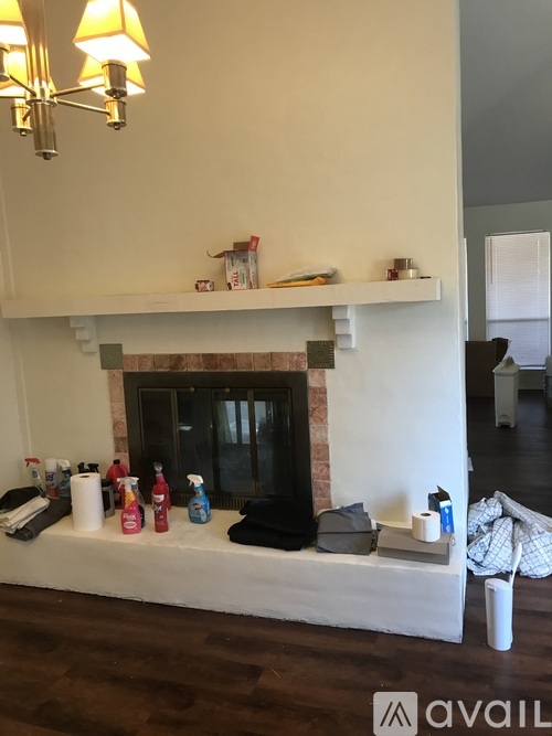 A white fireplace with a white mantle and a white shelf above it.