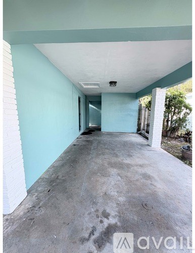 A long hallway with a white ceiling and walls painted in a light blue color.