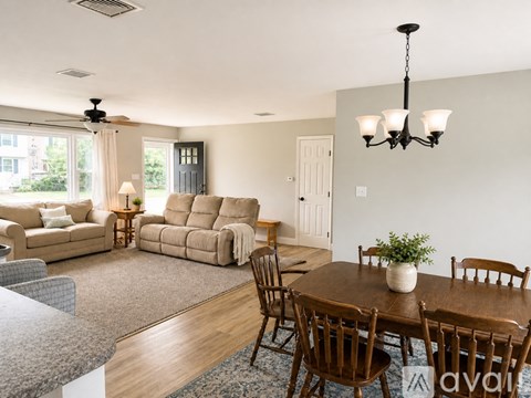 A living room with a brown table and chairs.