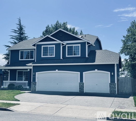 A two-story house with a garage on the side.
