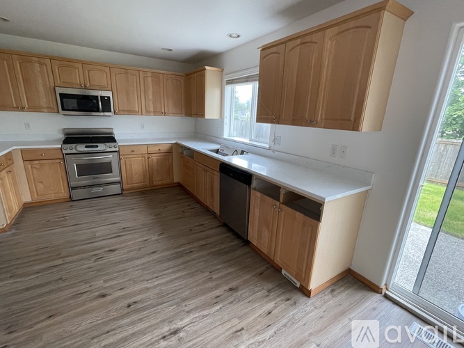 A kitchen with wooden cabinets and a white countertop.