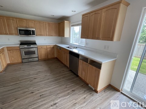 A kitchen with wooden cabinets and a white countertop.
