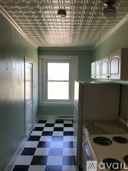 A room with a checkered floor and a window.