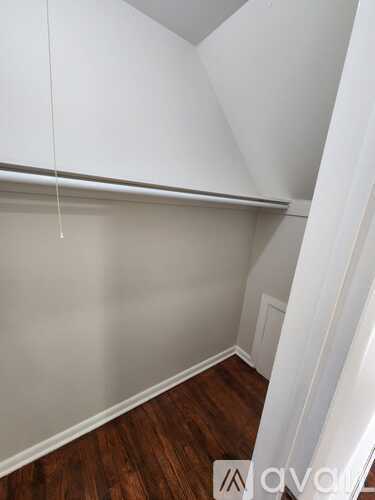 A room with white walls and wooden flooring.