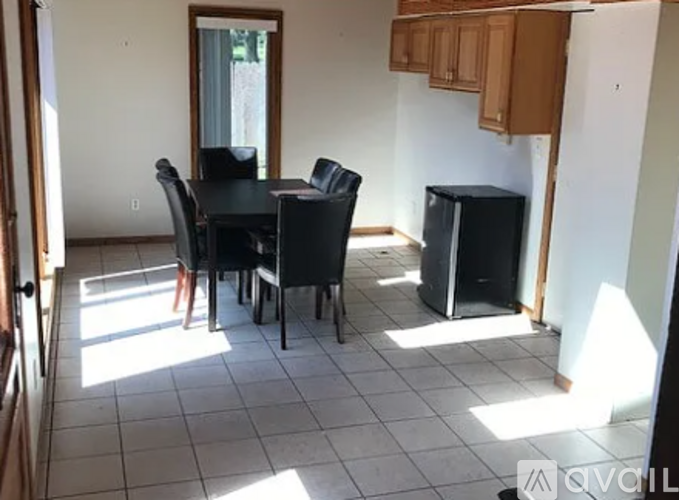 A dining room with a table and chairs.