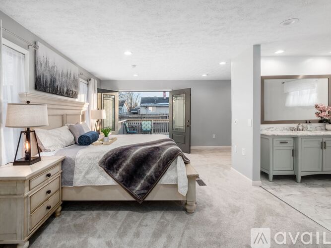 A bedroom with a large bed and a dresser.