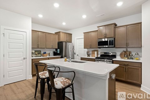 A kitchen with brown cabinets and a white island.