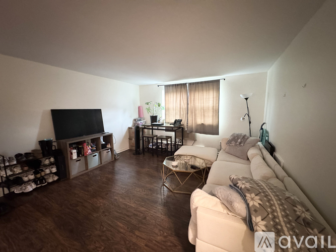 A living room with a white couch and a television.