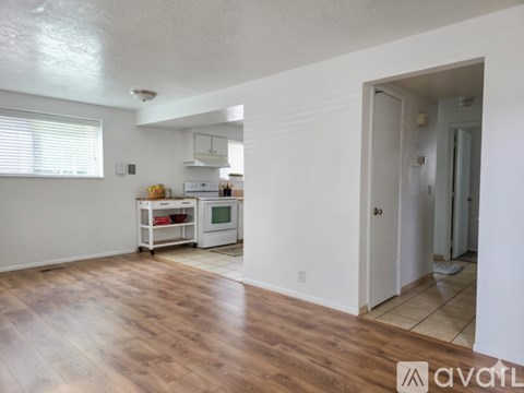 A kitchen area with a white oven and microwave.