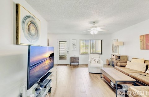 A living room with a television and a couch.