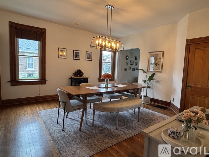 A dining room with a wooden table and chairs.
