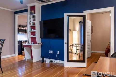 A living room with a television and a sliding door.