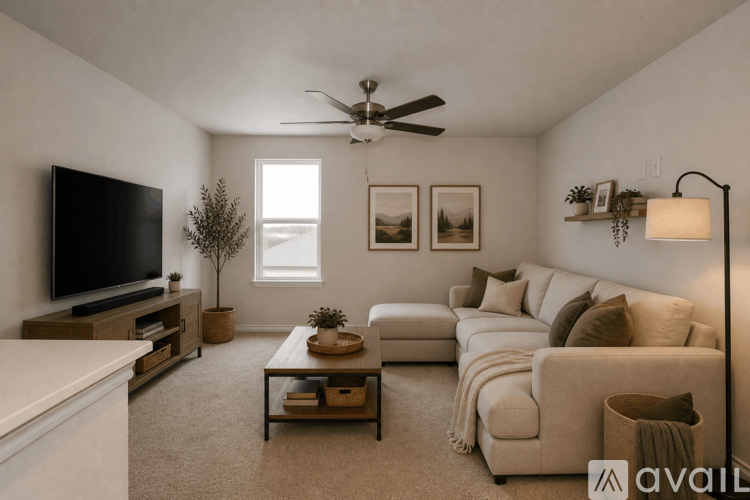A living room with a television, couches, and a ceiling fan.