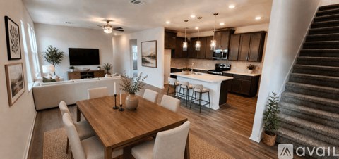 A modern kitchen with a dining table and chairs.