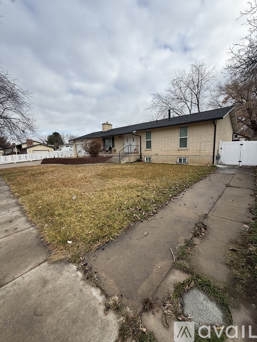 A house with a yard and a driveway in front.