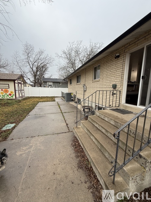 A house with a concrete walkway leading to the front door.