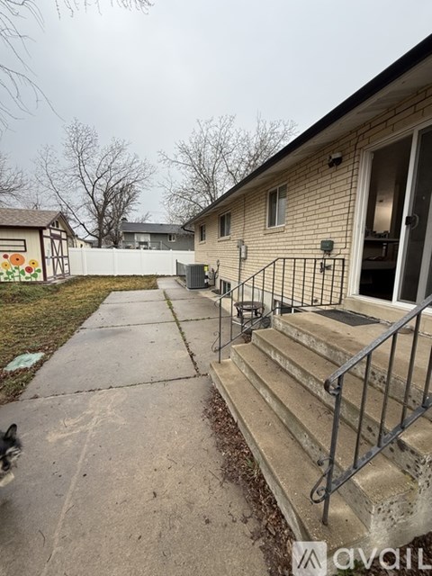 A house with a concrete walkway leading to the front door.