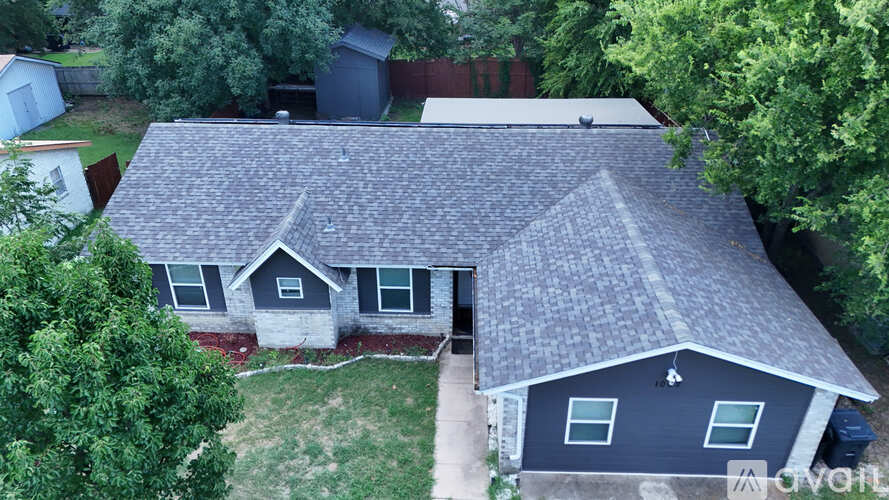 A house with a grey roof and a white garage door.