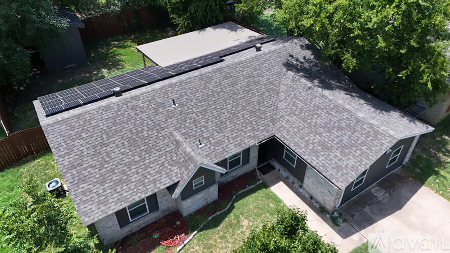 A house with a grey roof and a white garage door.