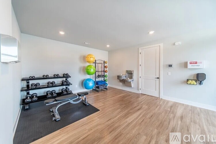 A gym room with a variety of exercise equipment.