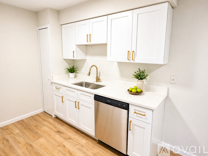 A kitchen with white cabinets and a stainless steel dishwasher.