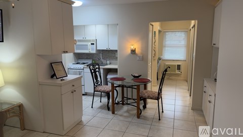 A kitchen with a table and chairs in the middle of the room.
