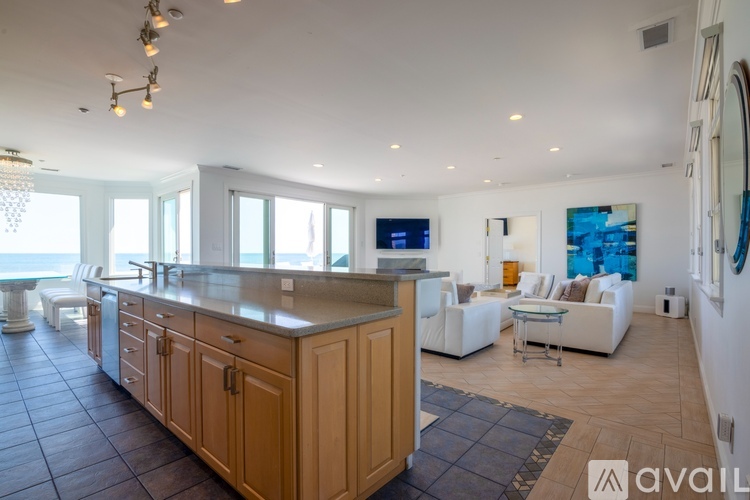 A modern kitchen with wooden cabinets and a large island.