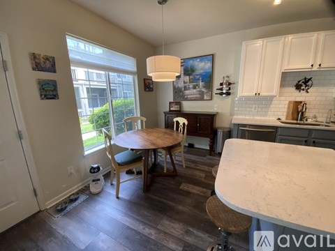 A kitchen with a table and chairs in the middle of the room.