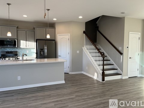 A kitchen with a stove top oven and a refrigerator.