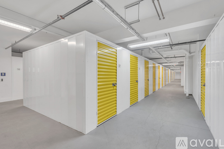 A long hallway with yellow doors and white walls.