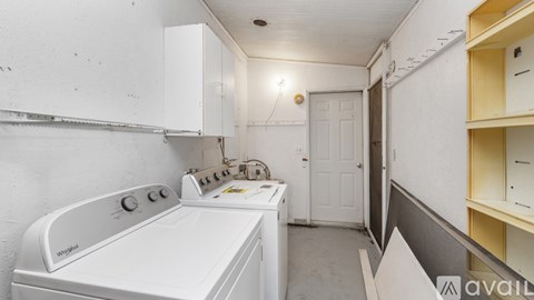 A white oven and stove top in a small kitchen.