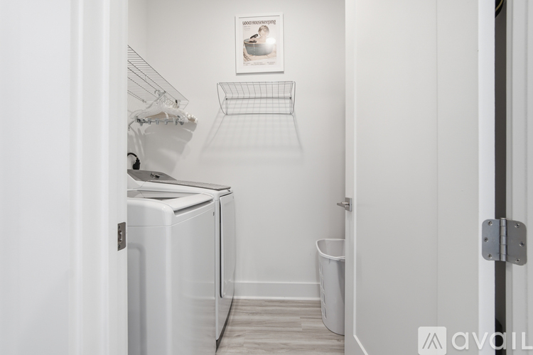 A small laundry room with a washer and dryer.
