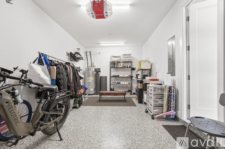 A room with a bicycle and a bench.