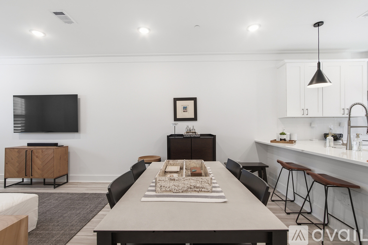 A modern kitchen with a dining table and chairs.
