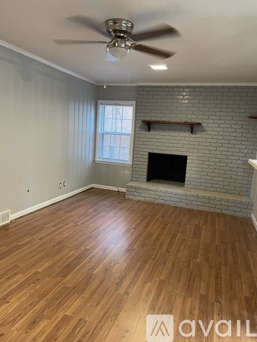 A room with a fireplace and a ceiling fan.