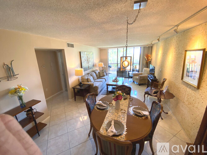 A dining room with a table set for a meal.