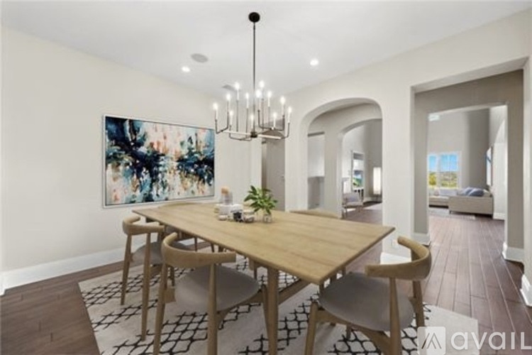 A dining room with a wooden table and chairs.